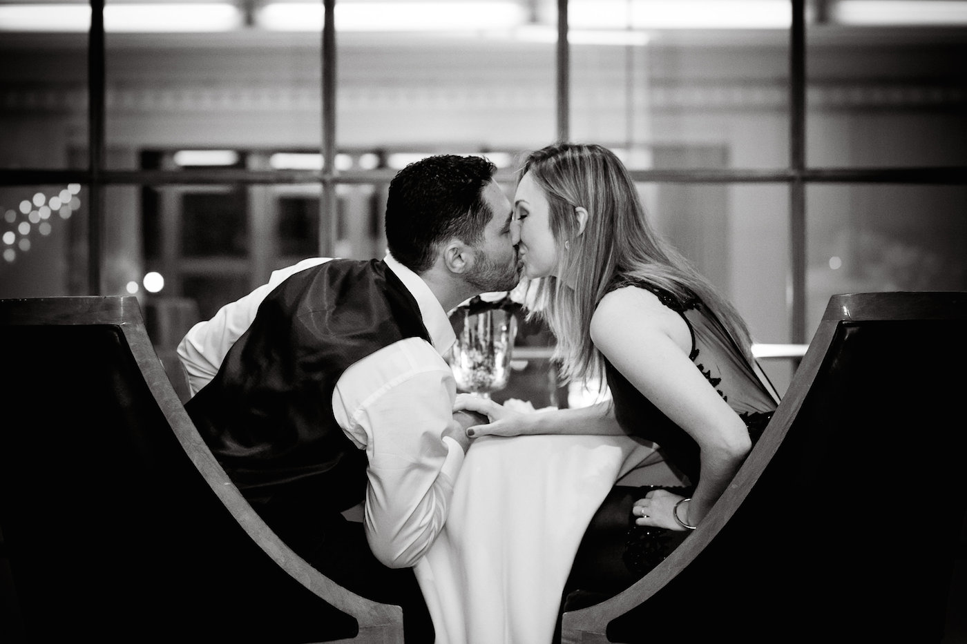 Couple kissing after unique proposal idea