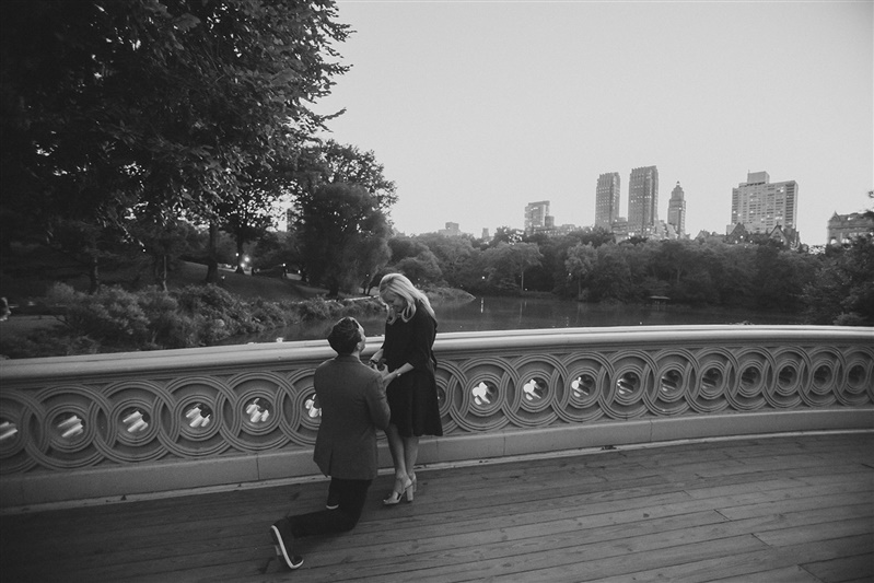man proposes on bow bridge