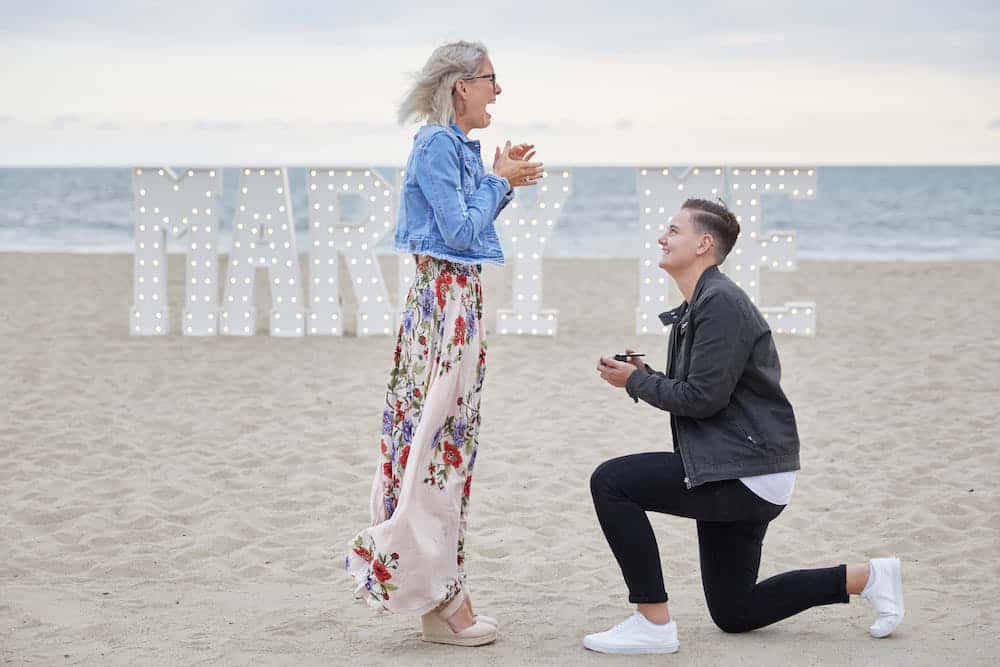 marry me sign on beach